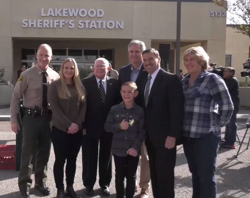 Sheriff's Captain and people standing next to building