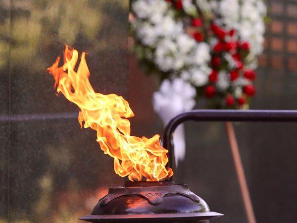 Ceremonial flame in front of the Memorial wall