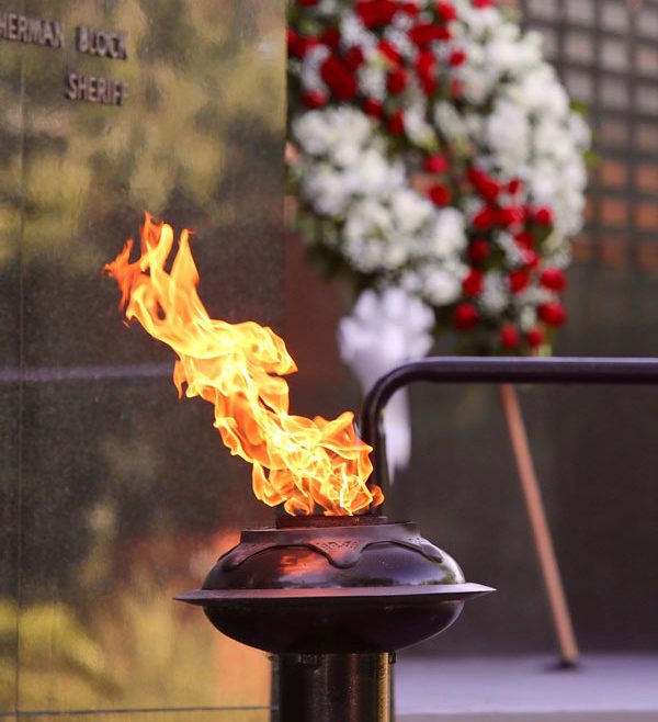Ceremonial flame in front of the Memorial wall
