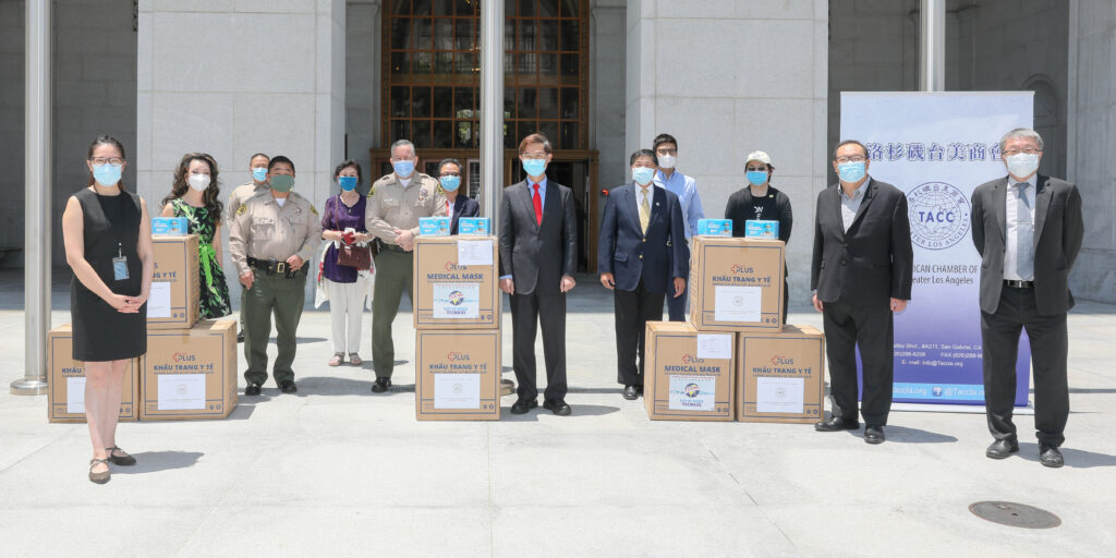 Sheriff and Undersheriff standing with boxes of masks and the TCCLA