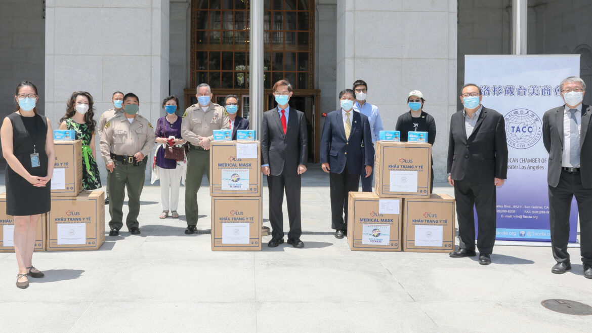 Sheriff and Undersheriff standing with boxes of masks and the TCCLA
