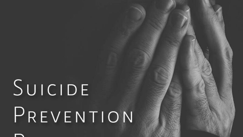 black and white image of a person with their hands folded over their face. words accross the top read "you are not alone". The next line reads " Suicide Revention Resources".