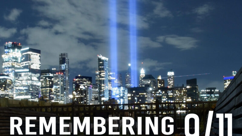 Remembering 9/11, image of two lights rising up from the Night time New York Sky line.